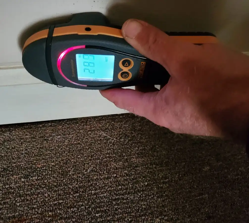 Moisture detection at baseboard during Storm Damage Restoration in San Juan Capistrano